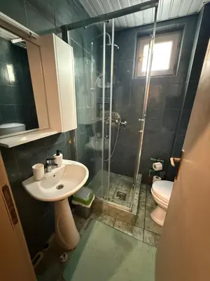 a bathroom with a shower and a sink and a toilet at Studio 75 meters to the sea in Rafailovici