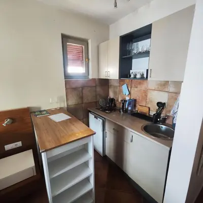 a small kitchen with a sink and a counter at Studio 75 meters to the sea in Rafailovici
