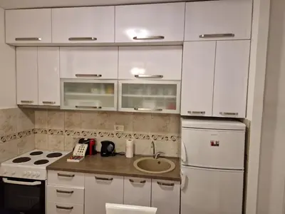 a kitchen with white cabinets and a sink at Your place in Podgorica in Podgorica