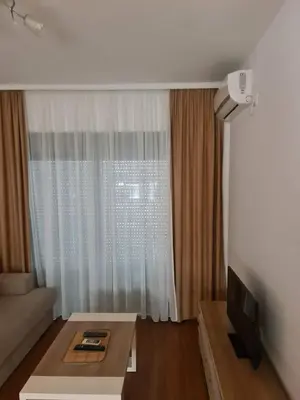 a living room with a couch and a table and a window at Ulcinj apartman 