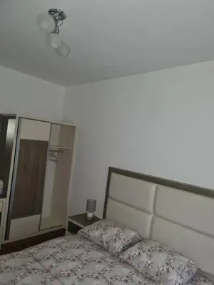 a bedroom with a bed and a large mirror at Ulcinj apartman 