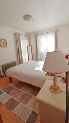 a bedroom with a bed with a lamp on a table at Apartment Kotor in Kotor