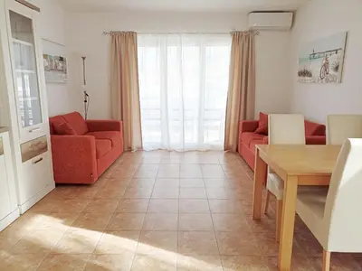 a living room with two red couches and a table at Apartment Kotor in Kotor