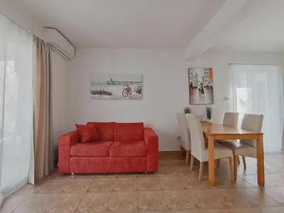 a living room with a red couch and a table at Apartment Kotor in Kotor