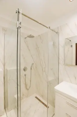 a shower with a glass door in a bathroom at Beachfront luxury apartment in Budva