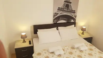 a bedroom with a bed with the eiffel tower at Gregovic Apartments in Petrovac na Moru