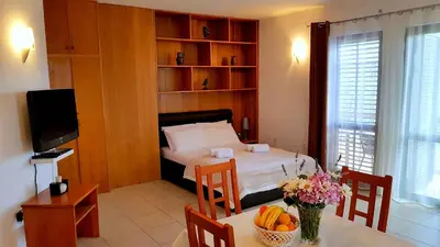 a bedroom with a bed and a table with fruit on it at Gregovic Apartments in Petrovac na Moru