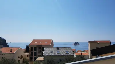 a view of the ocean from the roofs of buildings at Gregovic Apartments in Petrovac na Moru