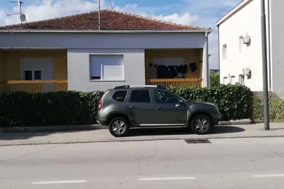 a gray car parked on the side of a street at Daydream Apartment in Podgorica in Podgorica