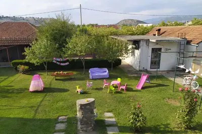 a backyard with a play area with pink furniture at Daydream Apartment in Podgorica in Podgorica
