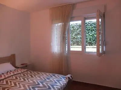 a bedroom with a bed and a window at Daydream Apartment in Podgorica in Podgorica