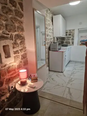 a kitchen with a table with a lamp on it at Bond studios- Old town in Kotor