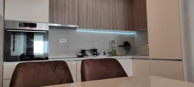 a kitchen with a table and two chairs in it at South Side Apartment in Podgorica