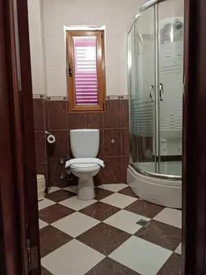a bathroom with a toilet and a glass shower at Villa Roselina By Beatrix in Budva