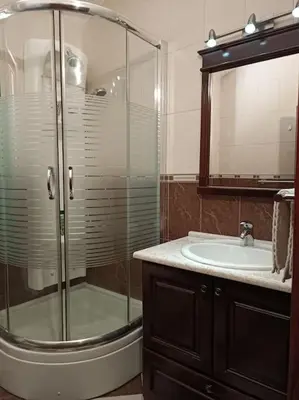 a bathroom with a glass shower and a sink at Villa Roselina By Beatrix in Budva