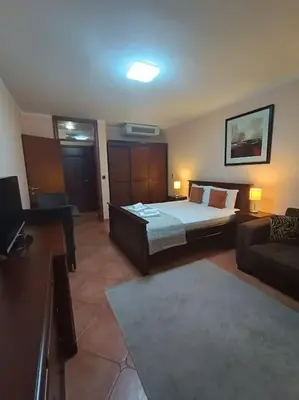 a hotel room with a bed and a couch at Villa Roselina By Beatrix in Budva