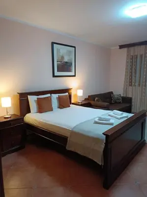 a bedroom with a large bed and a couch at Villa Roselina By Beatrix in Budva