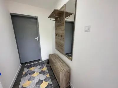 a bathroom with a mirror and a wooden bench at Vucinic Studio Apartment in Cetinje