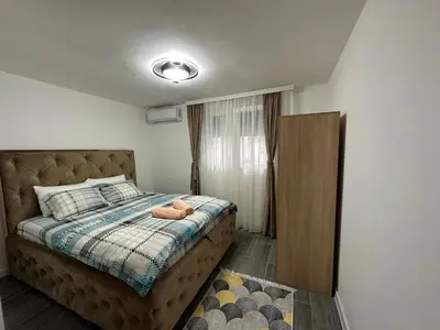 a bedroom with a bed with a stuffed animal on it at Vucinic Studio Apartment in Cetinje
