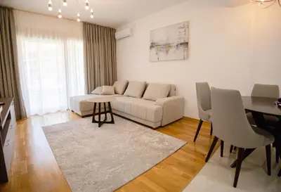 a living room with a couch and a table at Status-M Аpartments 133 in Becici