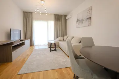 a living room with a couch and a table at Status-M Аpartments 133 in Becici