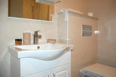 a bathroom with a white sink and a toilet at Status-M Аpartments 133 in Becici