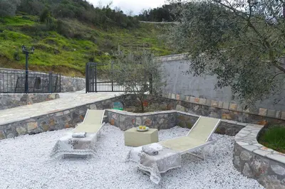 a patio with two chairs and a table at Villa 177 in Tivat