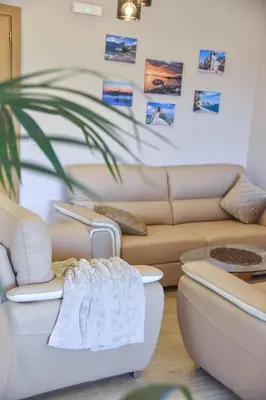 a living room with couches and a plant at Villa 177 in Tivat