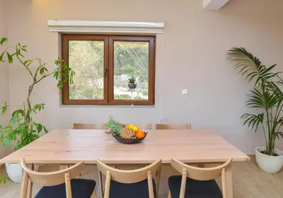 a dining room table with a bowl of fruit on it at Villa 177 in Tivat