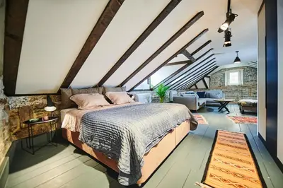 a bedroom with a bed and a living room at The Old Town Luxury Apartment by Montenegro Moments in Kotor