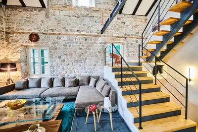a living room with a couch and a staircase at The Old Town Luxury Apartment by Montenegro Moments in Kotor