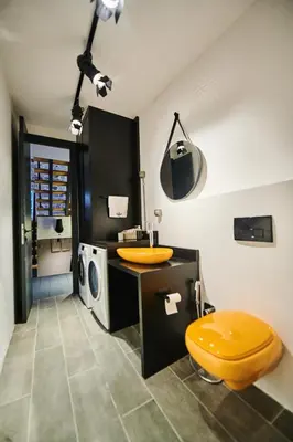 a bathroom with a yellow toilet and a sink at The Old Town Luxury Apartment by Montenegro Moments in Kotor