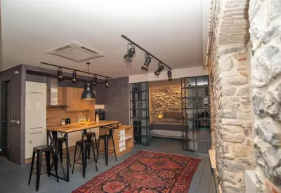 a kitchen and living room with a table and chairs at The Old Town Luxury Apartment by Montenegro Moments in Kotor