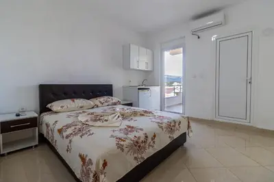 a bedroom with a bed and a large window at AS Apartments in Ulcinj