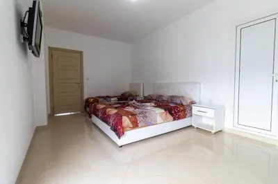 a bedroom with a bed and a large window at AS Apartments in Ulcinj