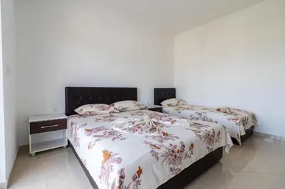 two beds sitting next to each other in a bedroom at AS Apartments in Ulcinj