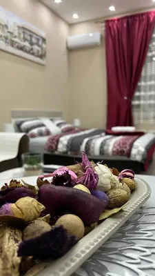 a tray of vegetables on a table in a room with beds at Apartment Downtown in Podgorica