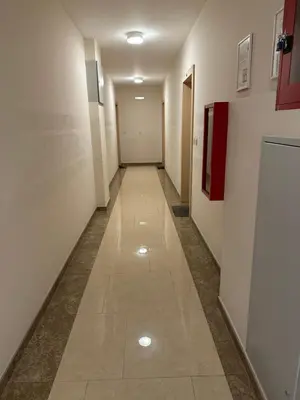 a hallway with white walls and a tile floor at City kvart 1 bedroom apartment in Podgorica
