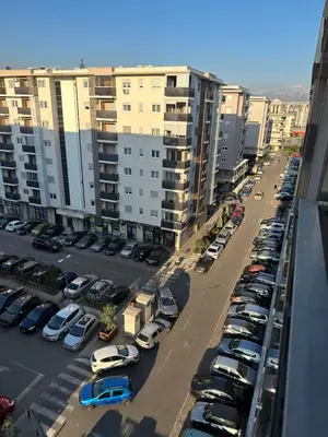 an aerial view of a parking lot with parked cars at City kvart 1 bedroom apartment in Podgorica