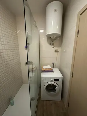 a small bathroom with a washing machine and a sink at City kvart 1 bedroom apartment in Podgorica