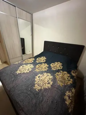 a bedroom with a bed with a black and gold bedspread at City kvart 1 bedroom apartment in Podgorica