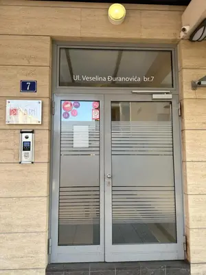 a door of a building with a sign above it at City kvart 1 bedroom apartment in Podgorica