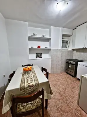 a kitchen with a table with oranges on it at Olive's apartment in Podgorica