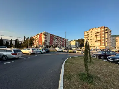 a parking lot with cars parked on the street at Ania apartment in Podgorica