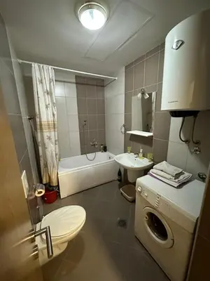 a bathroom with a toilet and a sink and a tub at Ania apartment in Podgorica