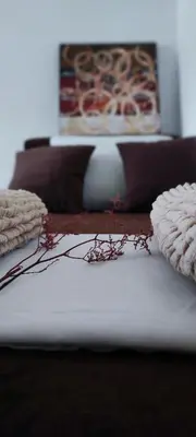 a bed with two pillows on top of it at Montenegrina apartment in Ulcinj