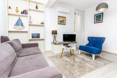 a living room with a couch and a desk at Apartman Petra in Pržno