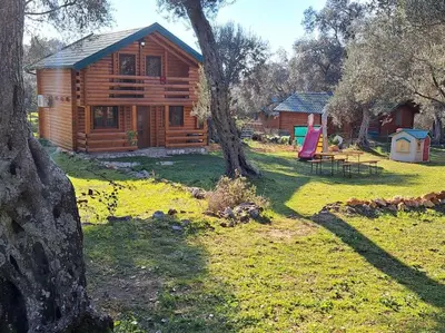 a log cabin with a picnic table and a tree at Olive & sea, Luxury two bedrooms cabin for 8 in Ulcinj