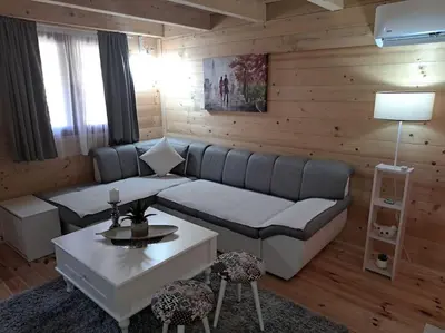 a living room with a couch and a table at Olive & sea, Luxury two bedrooms cabin for 8 in Ulcinj