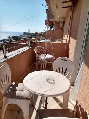 a white table and chairs on a balcony with a table at Apartmani Andrijana in Ulcinj